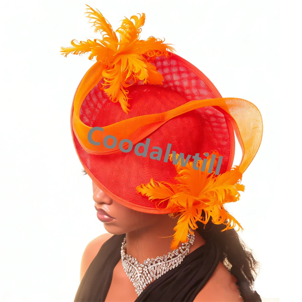 Elegant red and orange fascinator hat with vibrant feathers and swirling ribbon detail, worn by a mannequin.