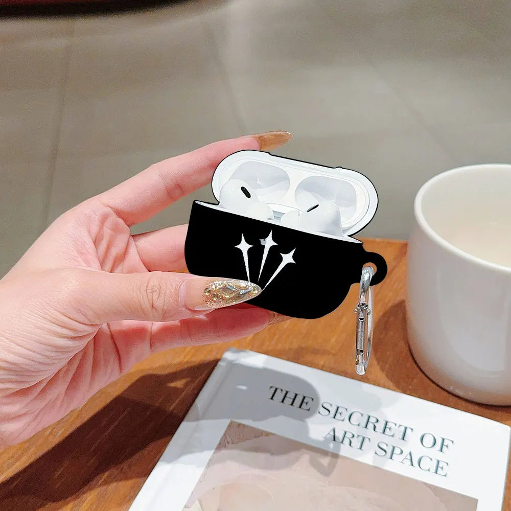 Black silicone AirPods Pro case with white star design and silver carabiner, held in a hand.