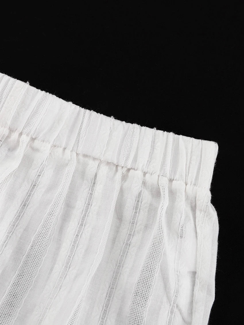 White, lightweight fabric with vertical textured stripes and a comfortable, gathered elasticated waistband.