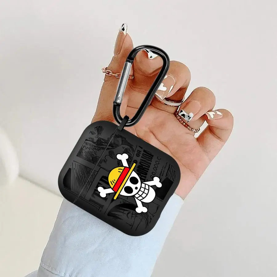 Black silicone AirPods case featuring a One Piece skull logo and carabiner clip held in a hand.