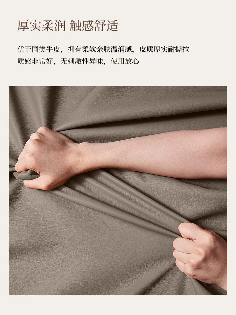 Close-up of hands stretching the soft, smooth, beige faux leather upholstery of a modern double bed frame.