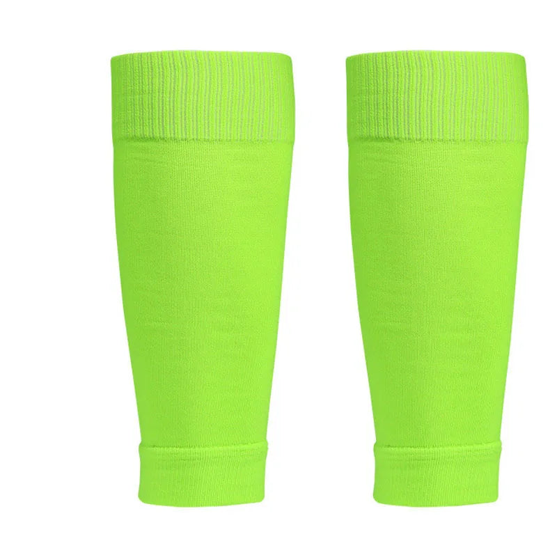 A pair of neon green calf compression sleeves with a ribbed elastic top band for secure fit.