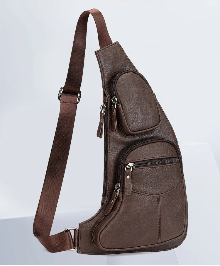Dark brown, textured faux leather sling bag with an adjustable strap and two zipped front pockets.