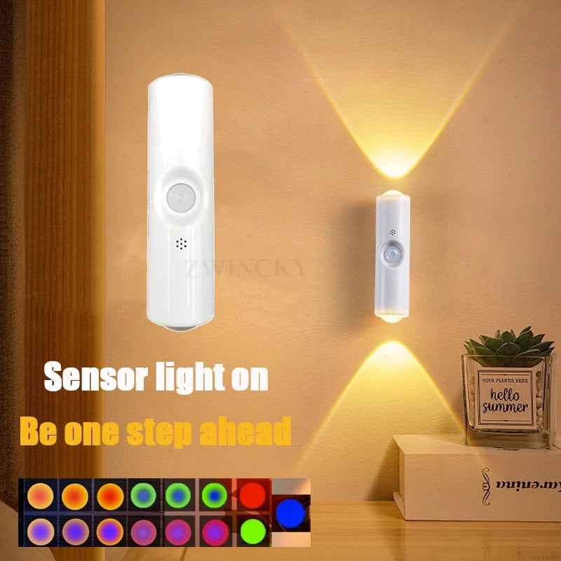 White, minimalist rechargeable LED wall lamp with motion sensor, emitting dual-directional warm light.