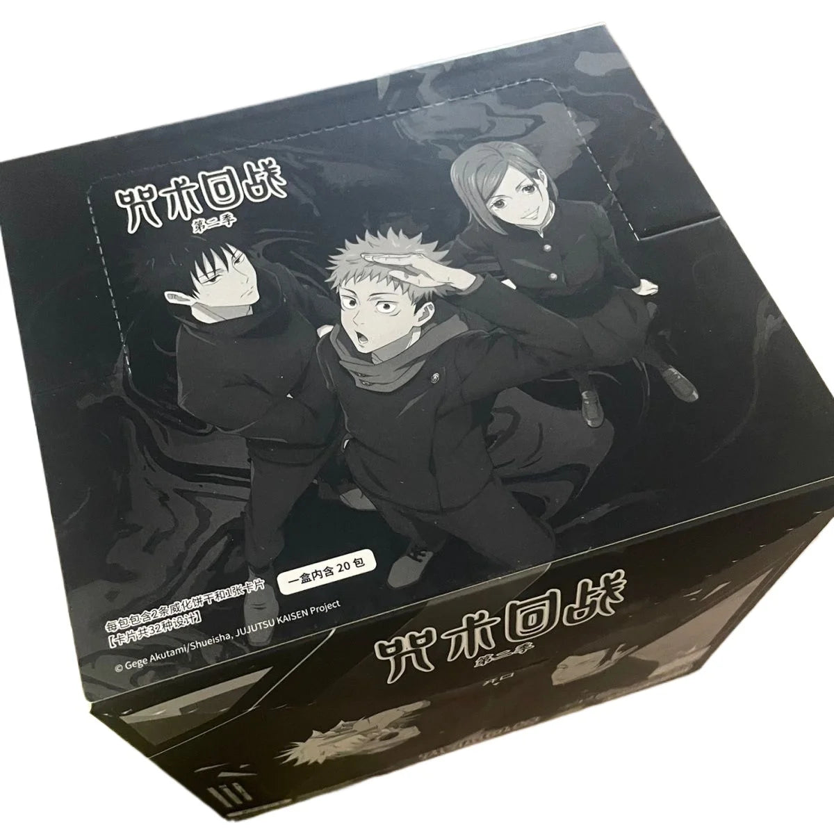 Jujutsu Kaisen trading card booster box featuring Megumi, Yuji, and Nobara in black and white.