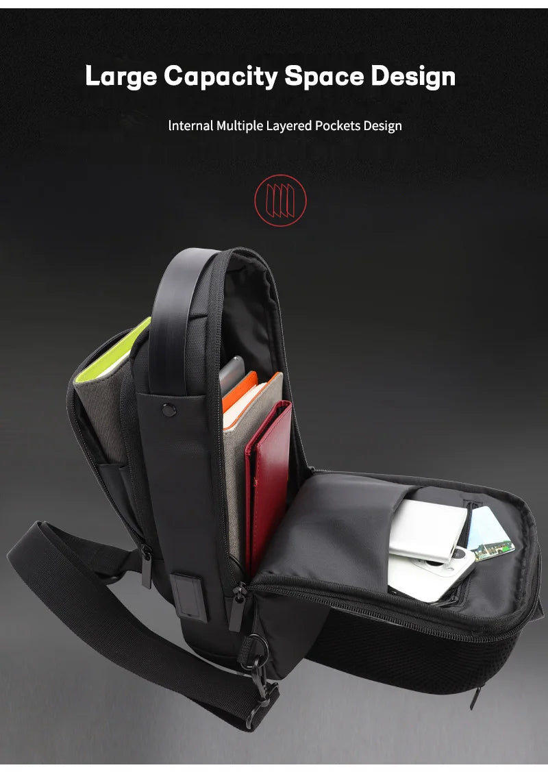 Black waterproof sling bag with an open main compartment showing multiple interior pockets, organisation, and USB port.