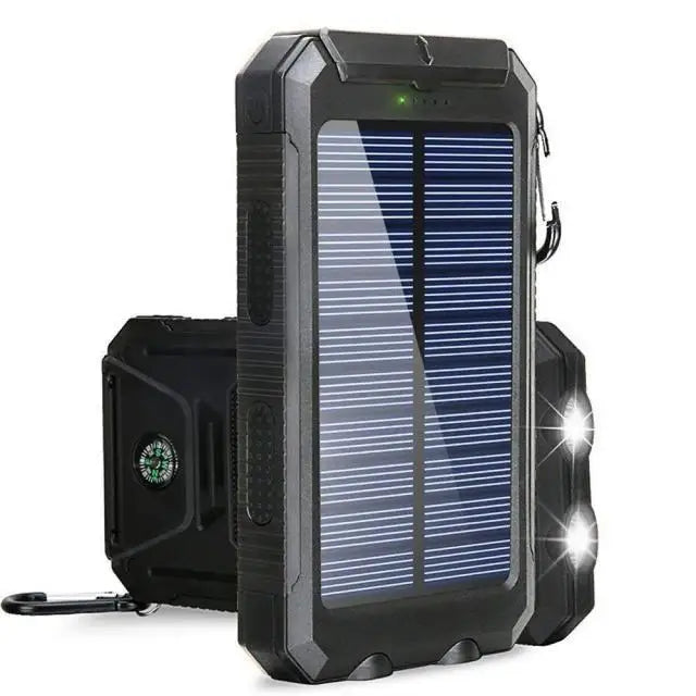 Rugged black solar power bank with built-in LED flashlight and side compass, shown from multiple angles.