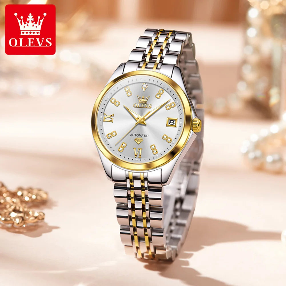 Elegant silver and gold-tone women’s stainless steel automatic watch with a jewel-accented face and date window.