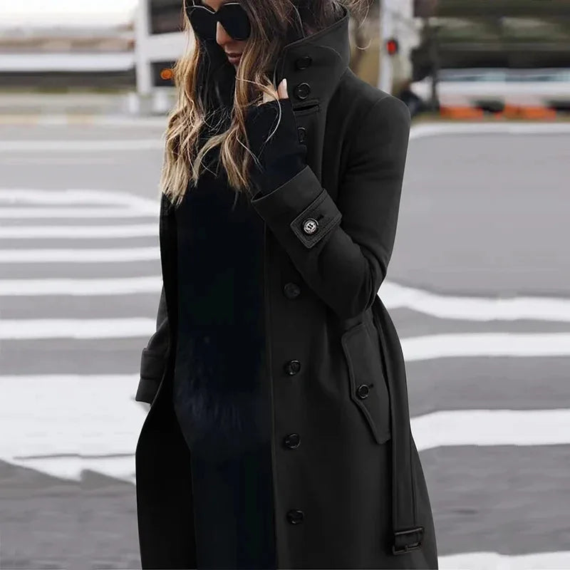 Stylish black longline coat with high collar, button-up front, and belted cuffs for a sophisticated winter look.
