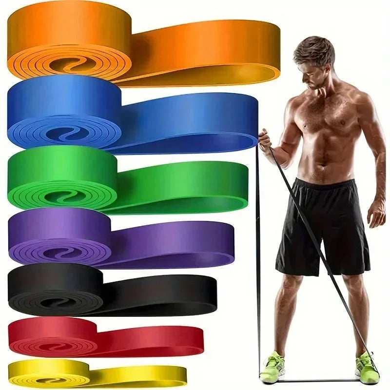 A set of seven multi-coloured resistance bands with a shirtless man demonstrating an exercise.