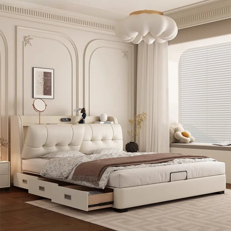 Modern off-white genuine leather bed frame with tufted headboard, integrated storage drawers and shelf in a bedroom.
