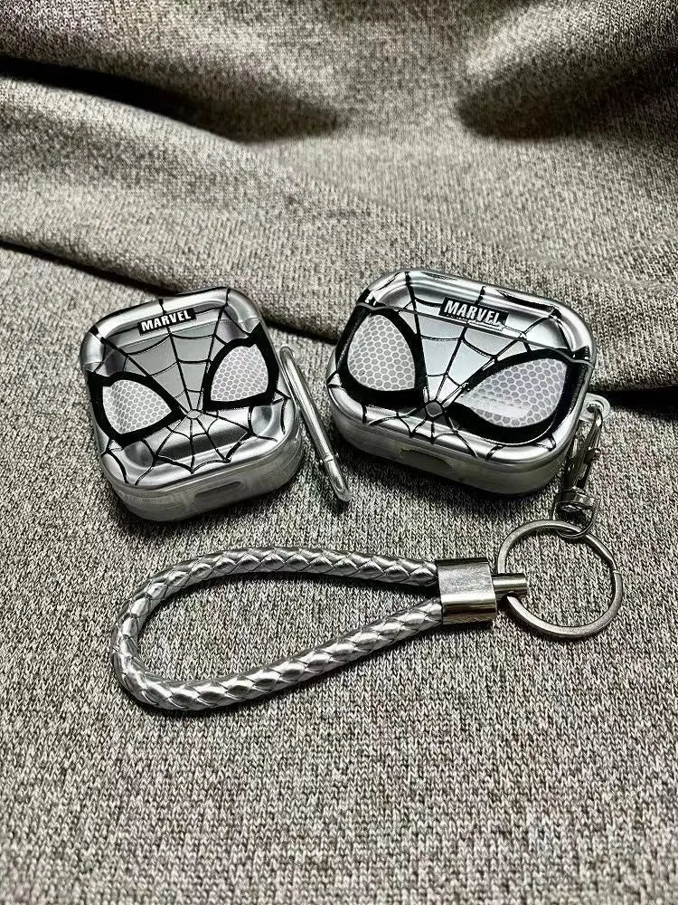 Silver metallic Marvel Spider-Man AirPod cases with woven keyring strap, featuring a black web and eye design.