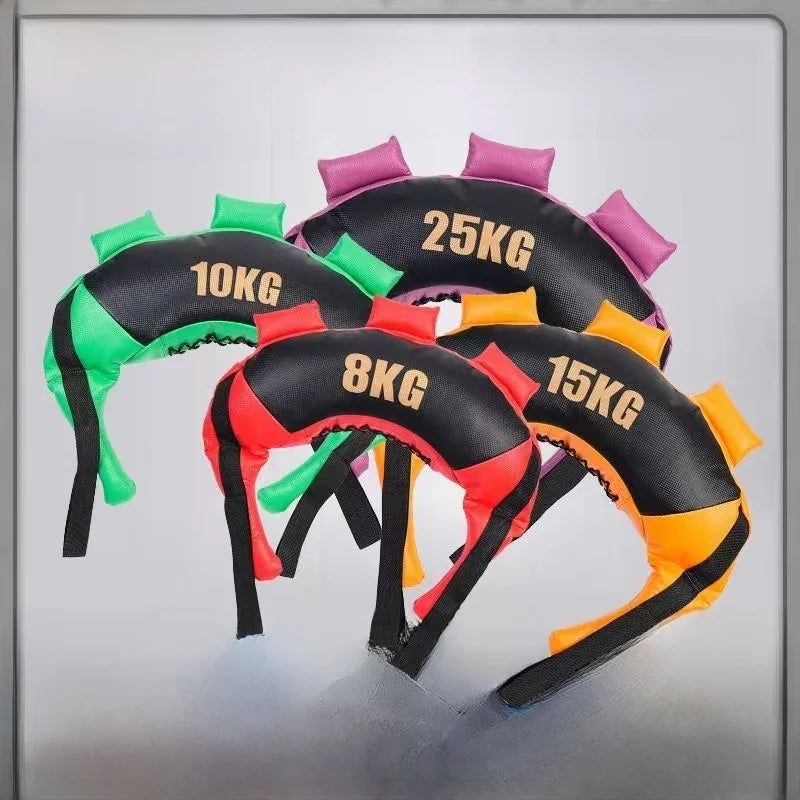 Four crescent-shaped weighted Bulgarian training bags in black with green, red, orange, and purple handles.