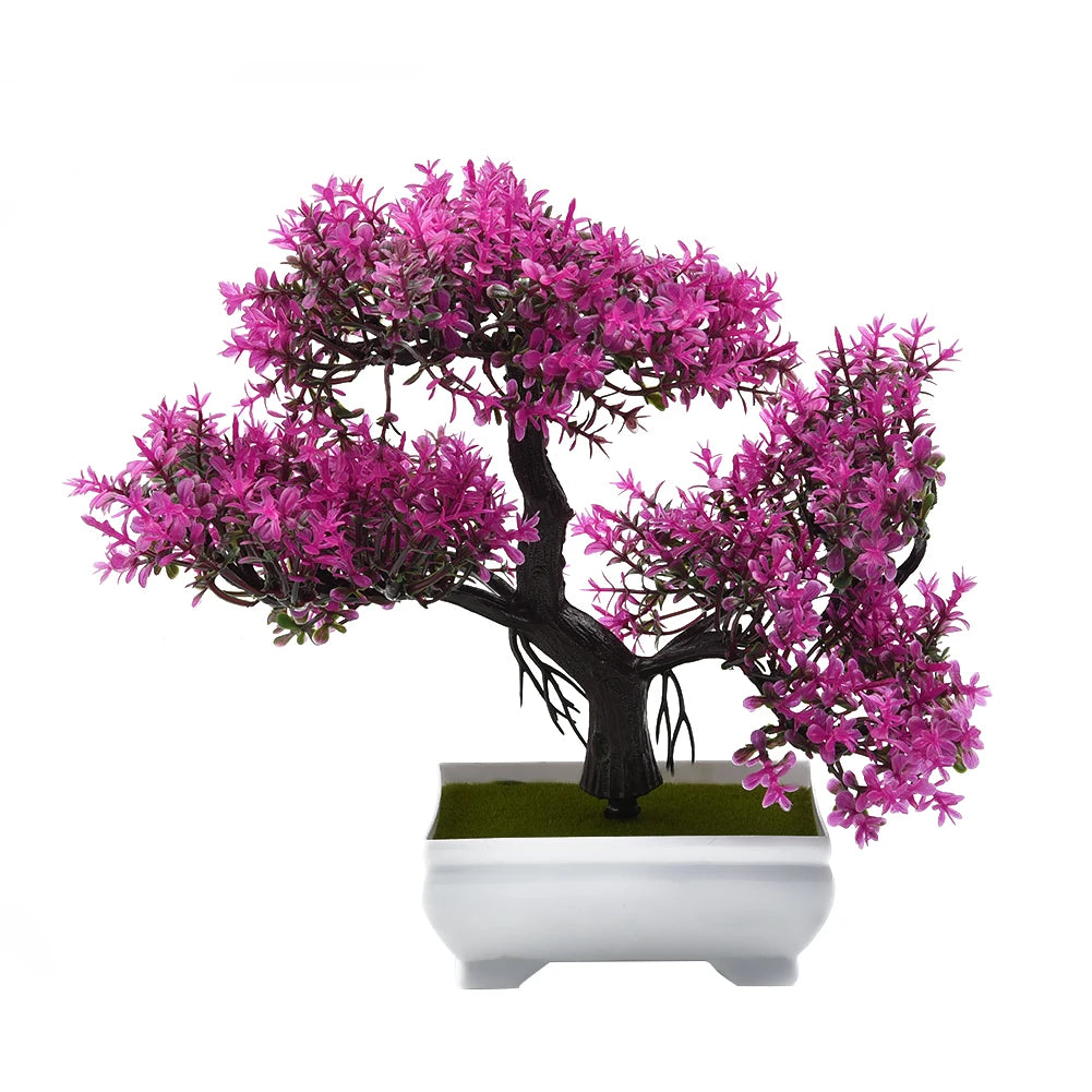 Artificial bonsai tree with vibrant magenta leaves, dark twisted trunk, and green base in a white square planter.