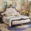 Opulent double bed with a button-tufted cream padded headboard, ornate black frame, and gold carved detailing.