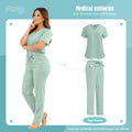 A model wearing a sage green V-neck scrub top and matching trousers with a tie-waist and side pockets.