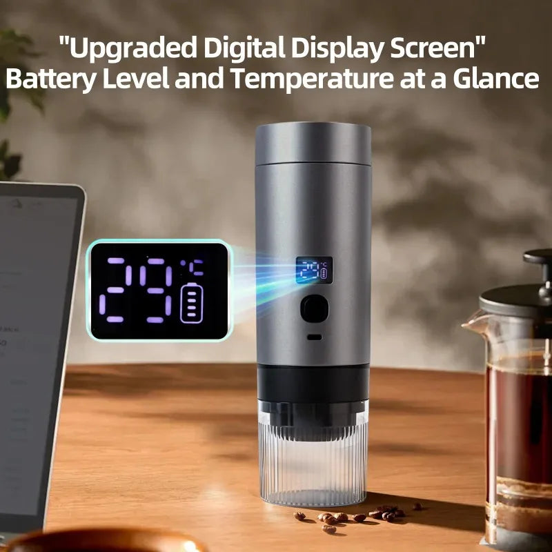 A silver, cylindrical portable coffee maker with a digital temperature and battery display stands on a wooden table.