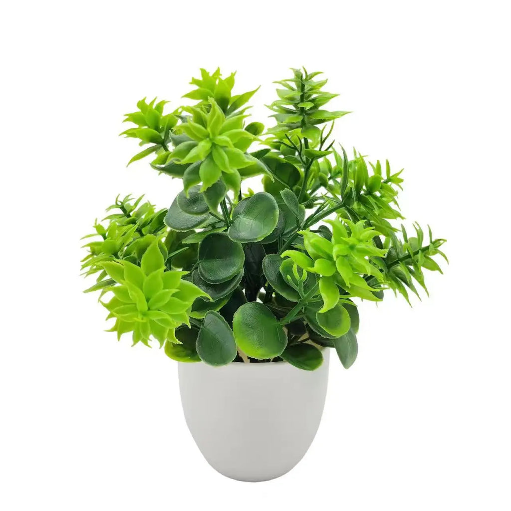 A small artificial plant with bright green, leafy foliage in a simple white rounded plastic pot, isolated on white.