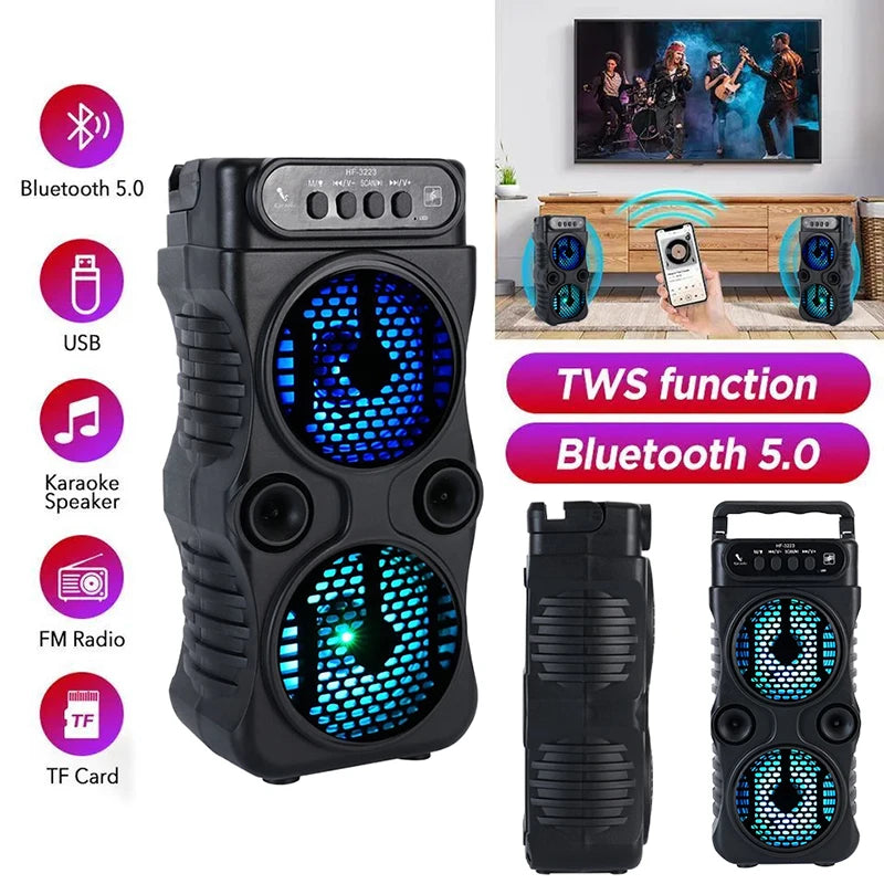 Portable black wireless speaker with twin blue LED-lit woofers, featuring Bluetooth, FM radio, and USB connectivity.