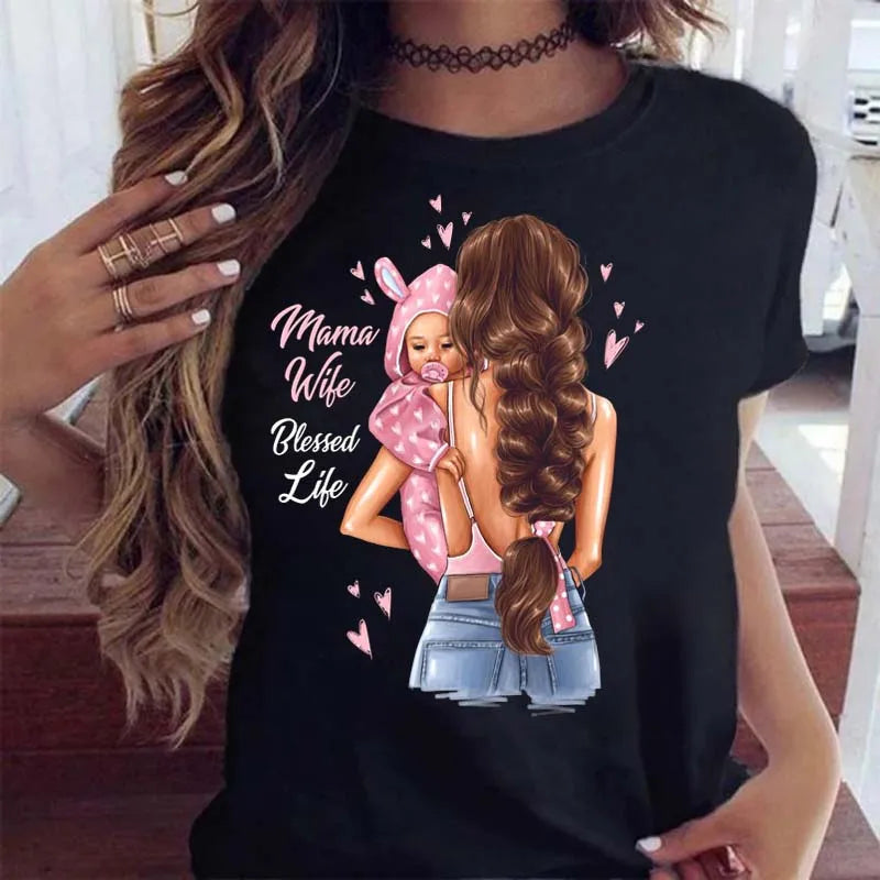 Black T-shirt featuring a graphic illustration of a mother carrying her baby with "Mama Wife Blessed Life" text.