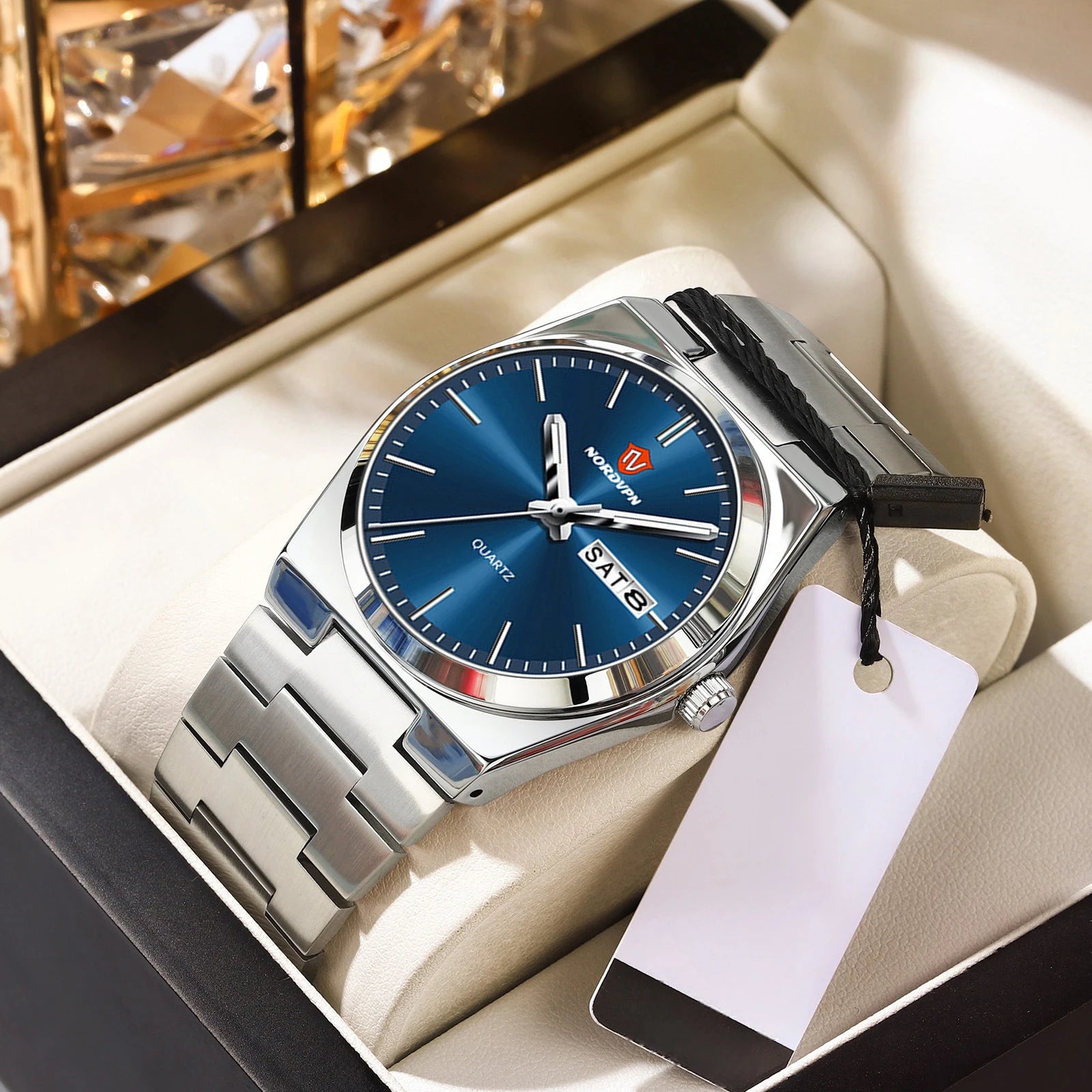 Ultra-thin silver quartz watch with a deep blue face, silver baton indices and a day-date display in a gift box.