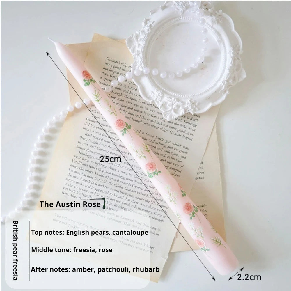 Pale pink tapered candle (25cm) featuring a delicate rose and floral print, elegantly displayed with white pearls.
