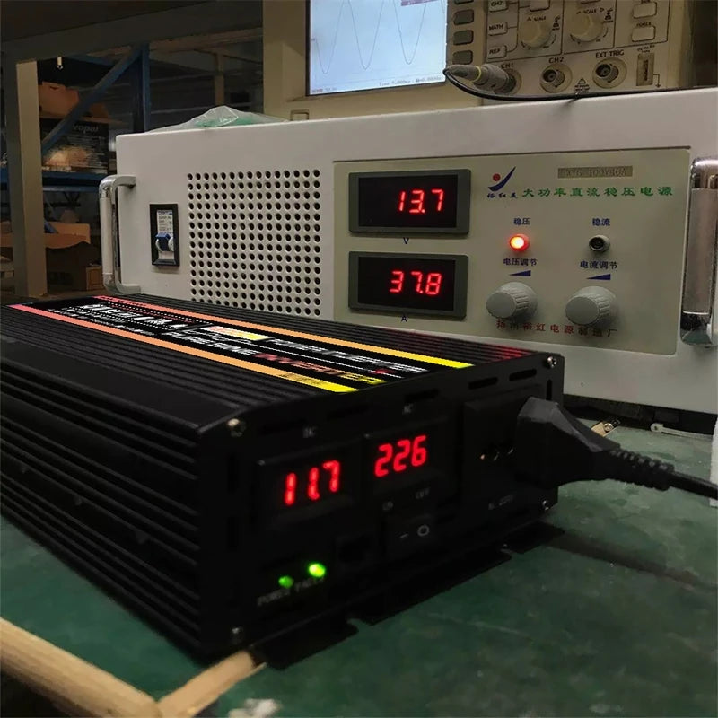Black 12000W pure sine wave power inverter with a digital display, shown connected to a laboratory power supply unit.