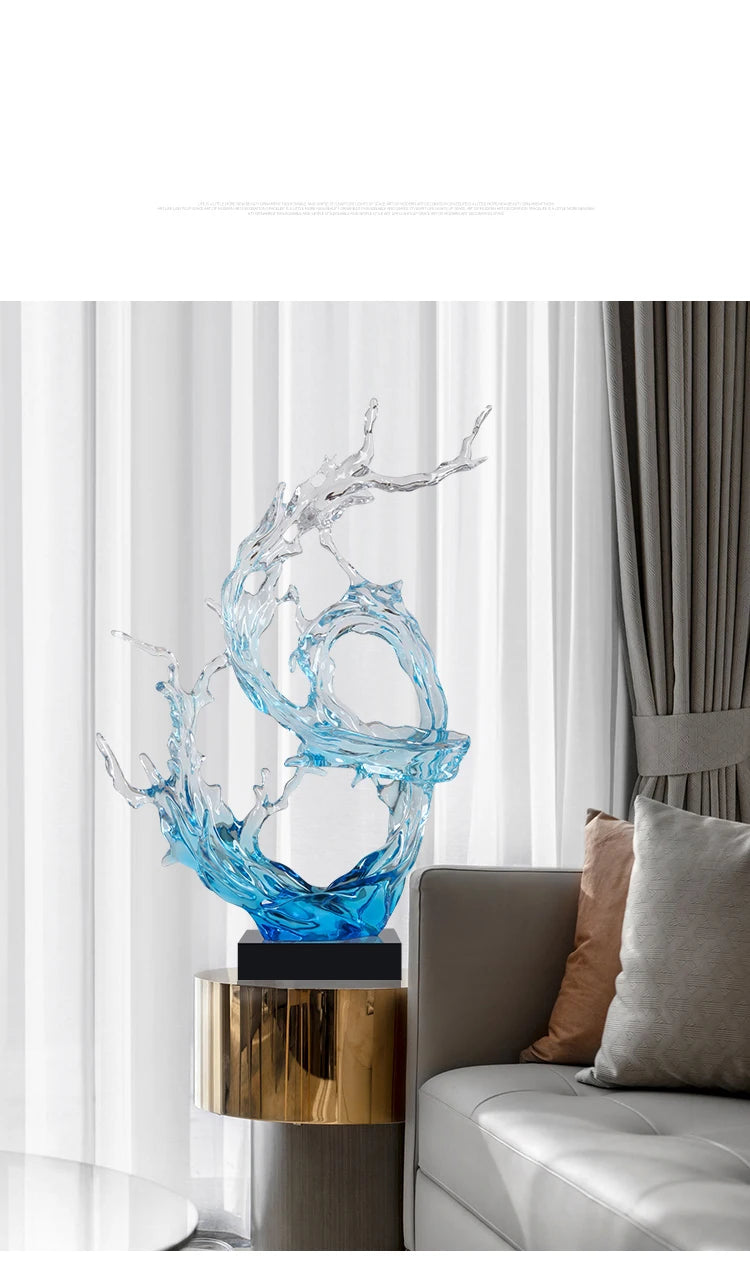 Modern resin ornament featuring a blue and clear abstract splash design on a black base, styled on a gold side table.