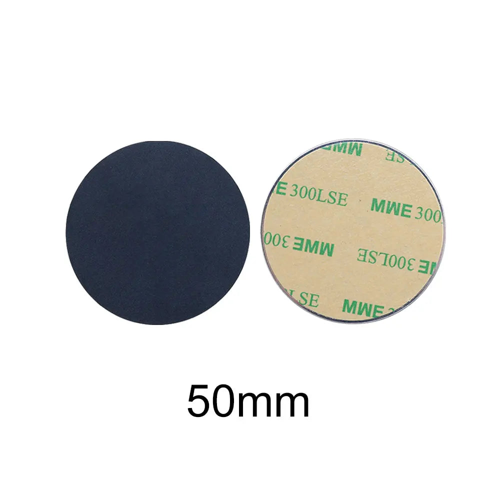 Two 50mm circular adhesive pads: one solid black, one showing the beige peel-off backing with green printed text.