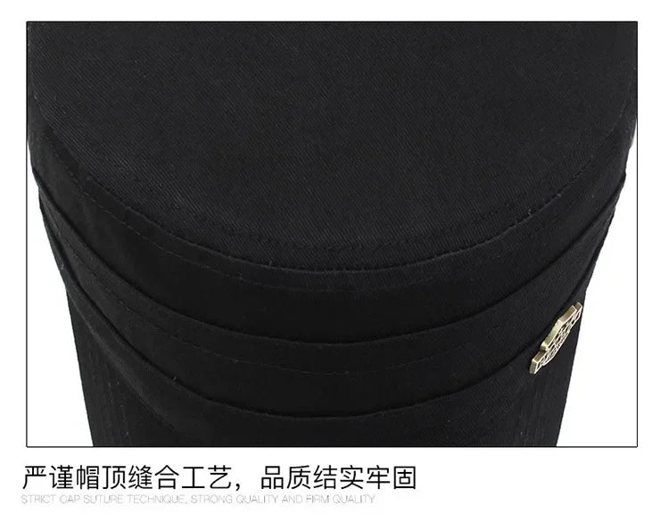 Close-up of a black cotton baseball cap showing durable, high-quality stitching and a small metallic side detail.