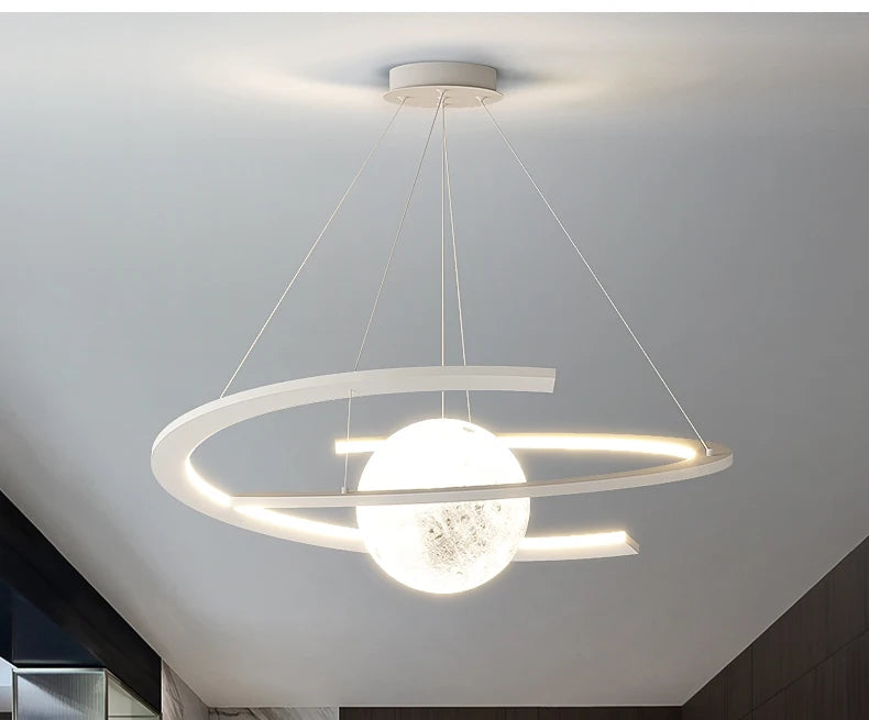 Modern matte white pendant light with a central glowing sphere surrounded by an illuminated circular ring frame.