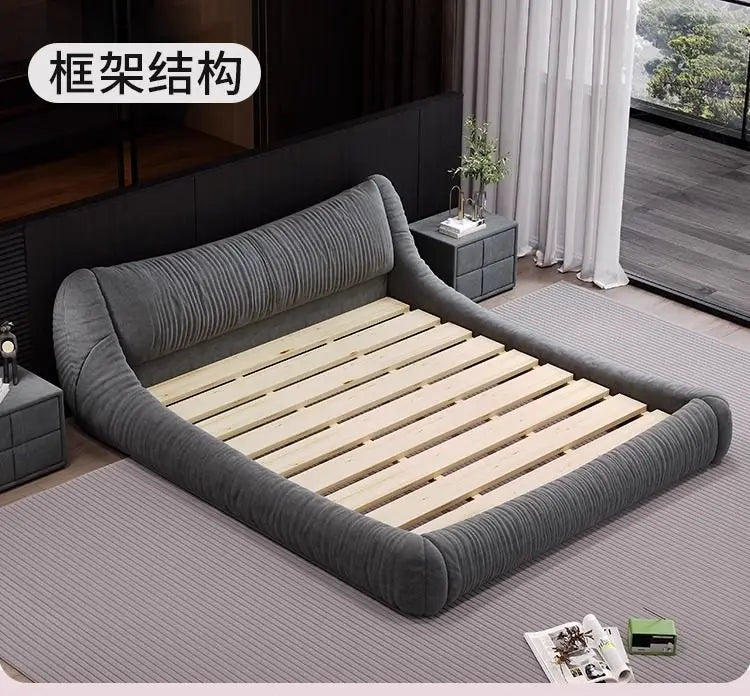 Modern grey upholstered low-profile bed frame with a textured headboard and exposed wooden slat base.