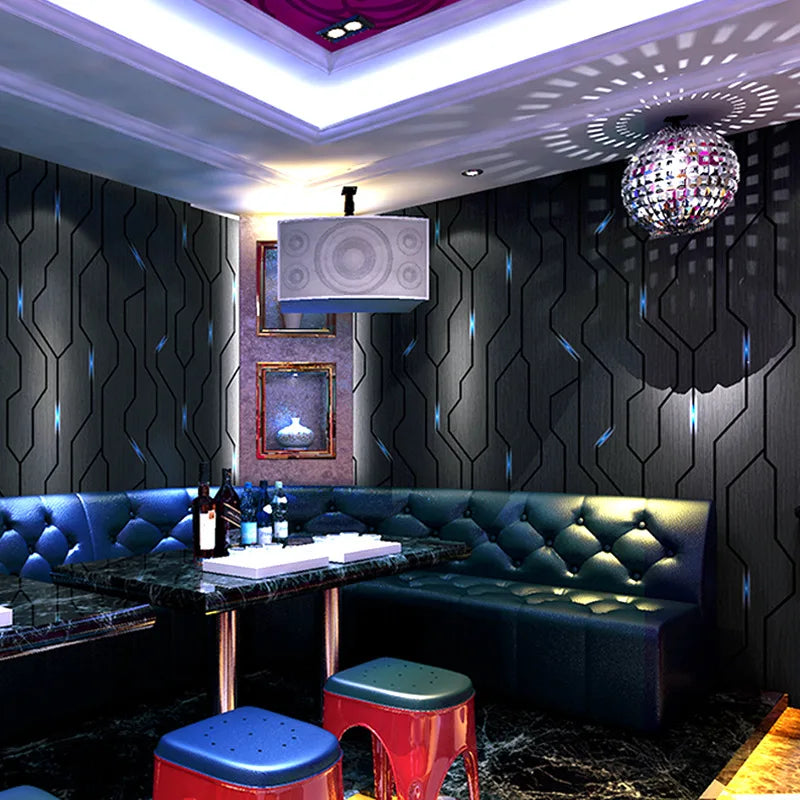 Modern, dark grey wallpaper with a 3D geometric linear pattern and subtle reflective blue accents for a feature wall.