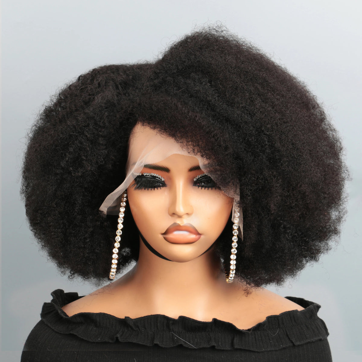 Black kinky curly human hair bob lace front wig on mannequin with natural hairline and voluminous afro style.