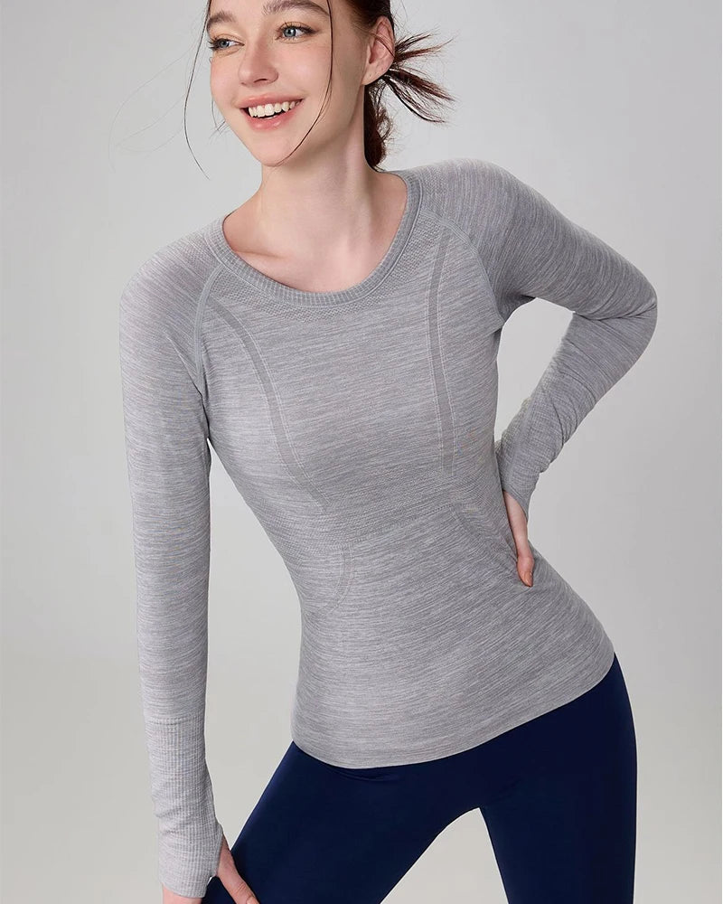 Grey marl seamless long-sleeve gym top for women, featuring a crew neck and fitted silhouette.