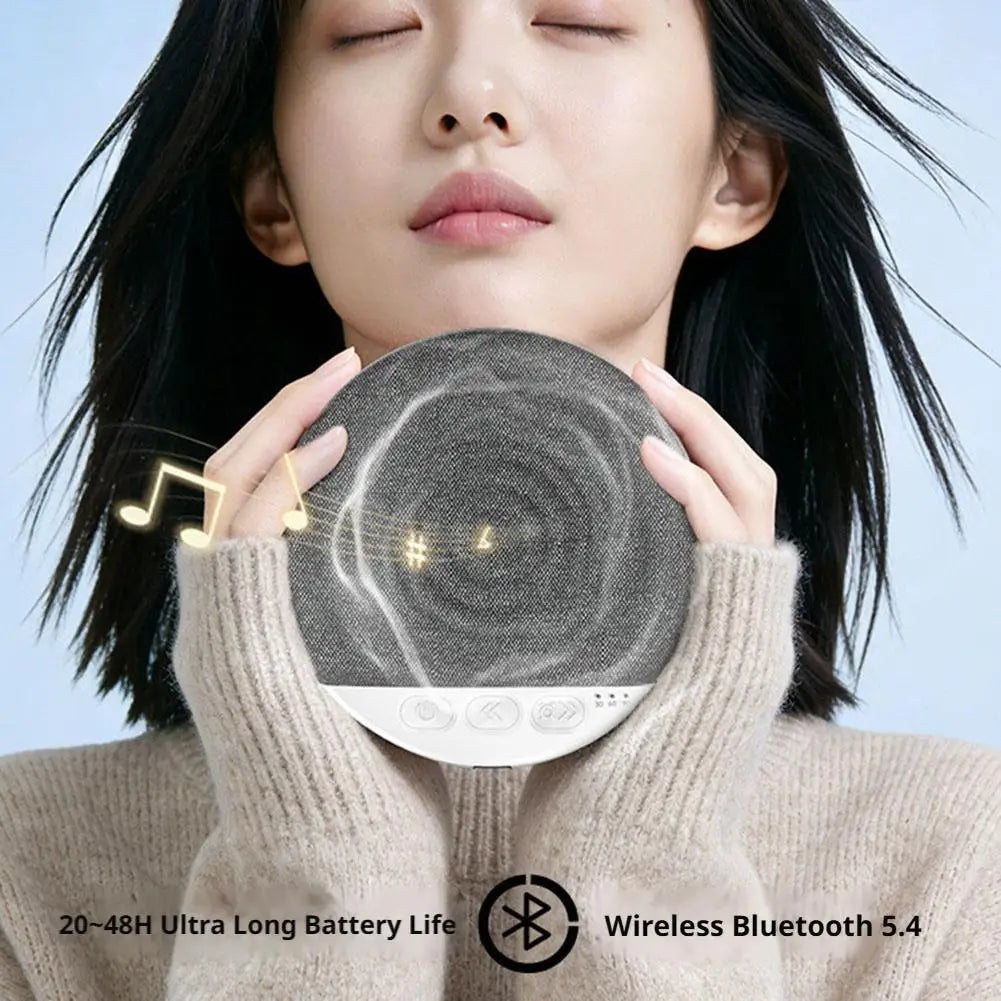 A woman holding a circular grey fabric Bluetooth sleep speaker with control buttons and music note graphics.