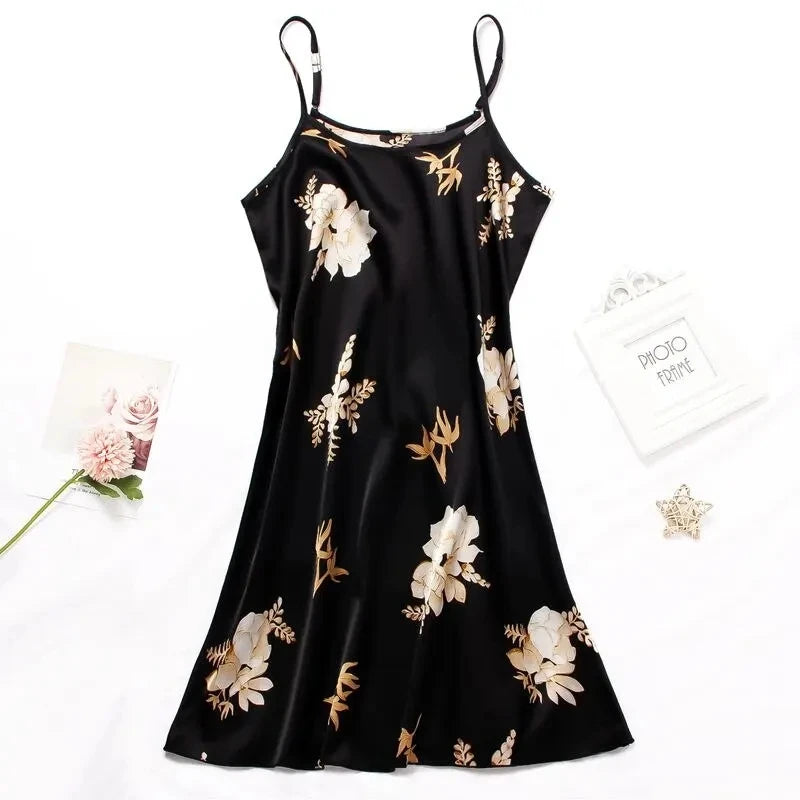 Black satin slip nightdress with adjustable spaghetti straps and elegant cream floral print.