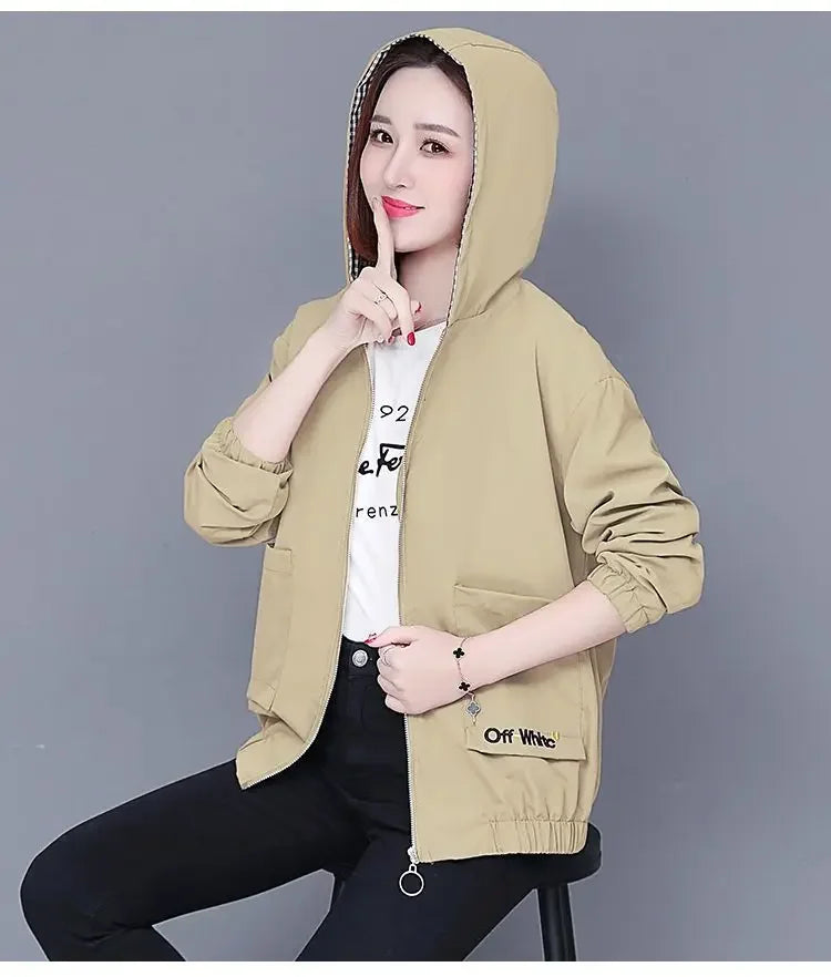 Women wearing a beige hooded zip-up jacket with elastic cuffs, a plaid-lined hood, and front flap pockets.