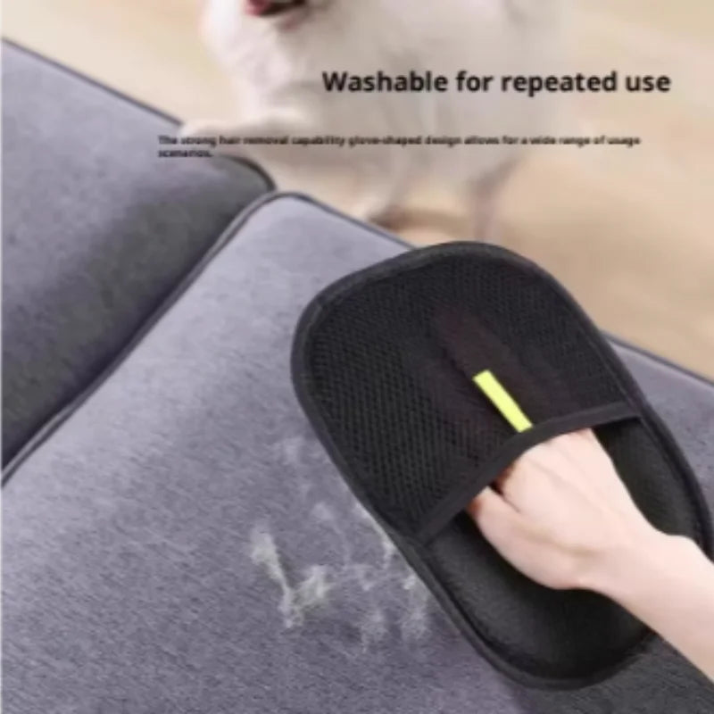 A black fabric pet hair removal mitt being used to clean grey sofa upholstery.