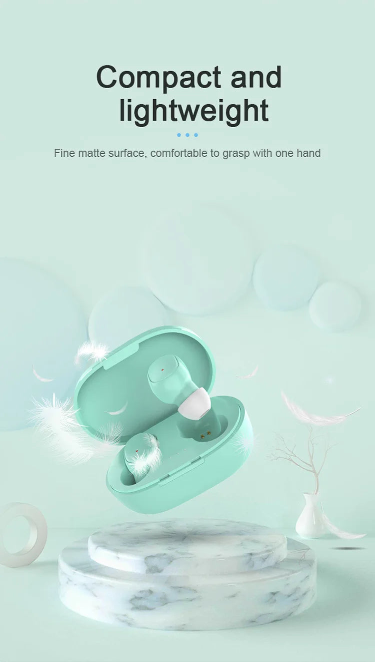 Mint green wireless earbuds with white tips inside a compact, matte-finish charging case, displayed on a marble base.