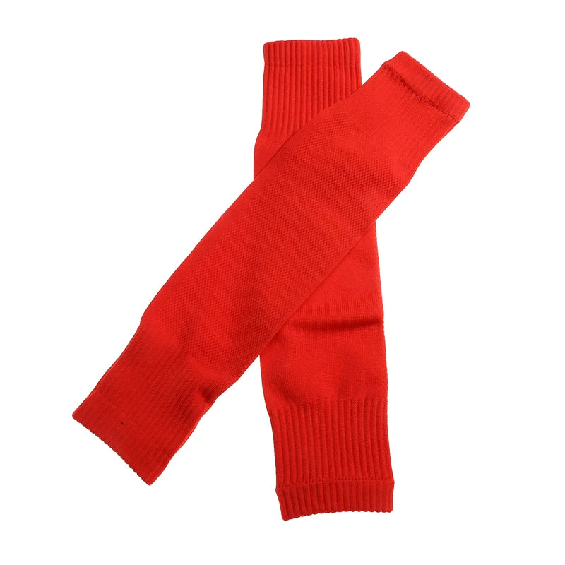 A pair of plain red football sock sleeves with ribbed cuffs, shown crossed over against a white background.