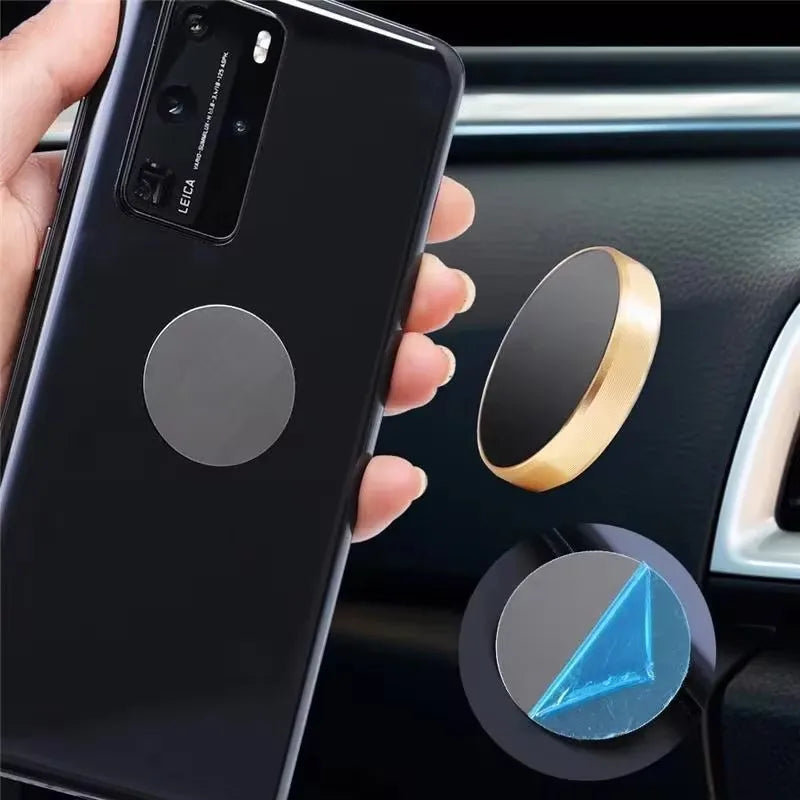Magnetic car phone mount with a gold circular design, shown with a smartphone and adhesive metal disc.