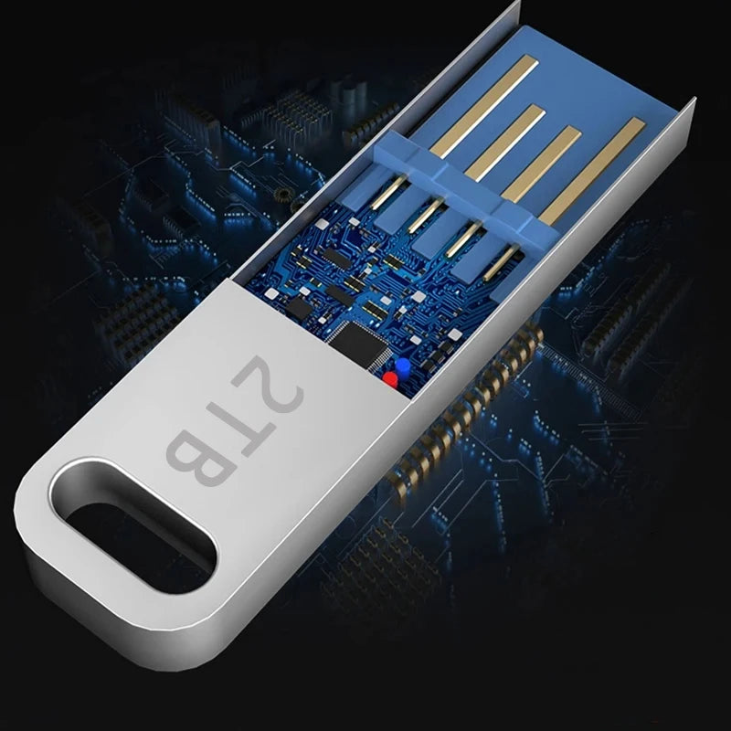 Sleek silver 2TB portable USB flash drive with a metallic casing, keyhole design, and exposed blue circuit board.