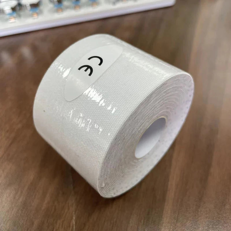 A roll of white kinesiology sports tape on a wooden surface, featuring a CE mark label.