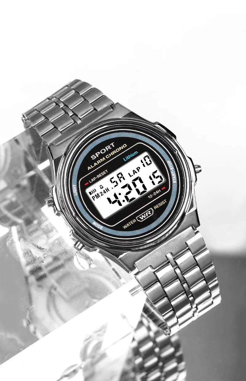 Retro silver-tone digital watch with a metal link bracelet and clear LCD display face.