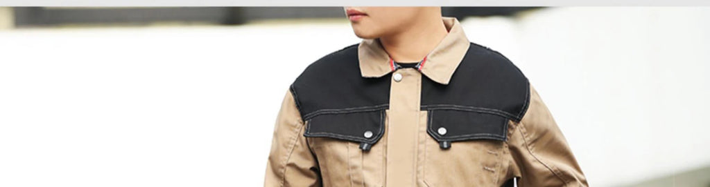 Model wearing a beige work jacket with black shoulder panels, a button-down collar, and front chest pockets.