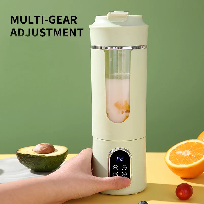 A light green portable blender with a digital display and multi-gear settings, positioned on a table with fruit.