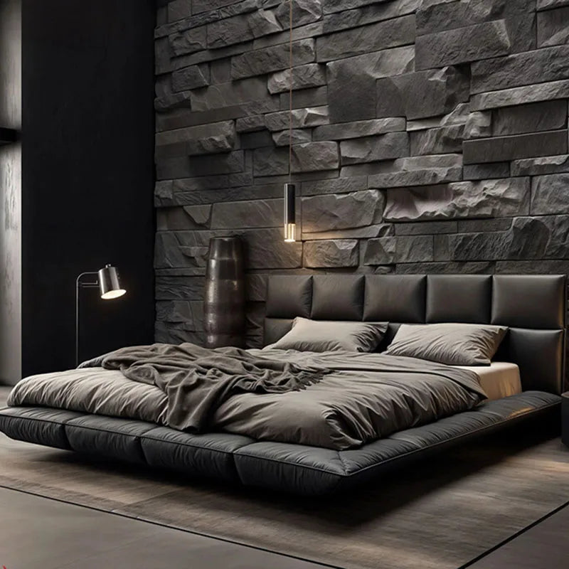 Modern king-size floating bed upholstered in dark grey leather with a matching panelled headboard.