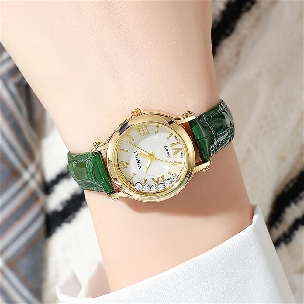 Women's gold-tone quartz watch with a green crocodile-effect leather strap and crystal detailing on the face.