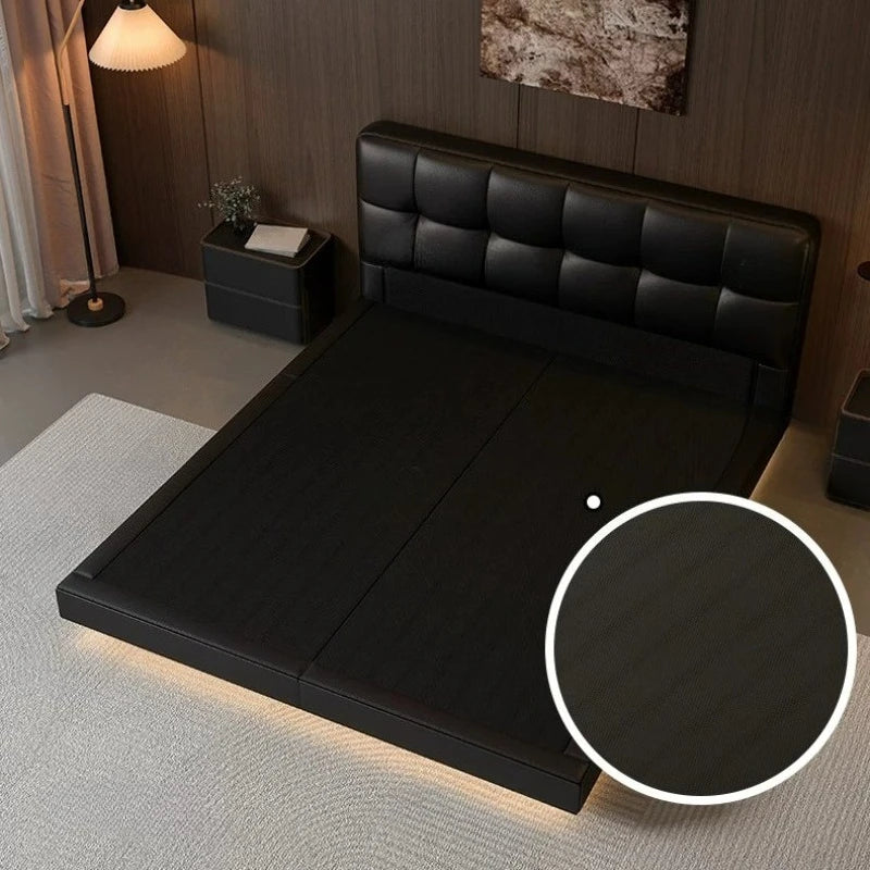Modern black leather double bed with a tufted headboard and integrated under-bed lighting, creating a floating effect.
